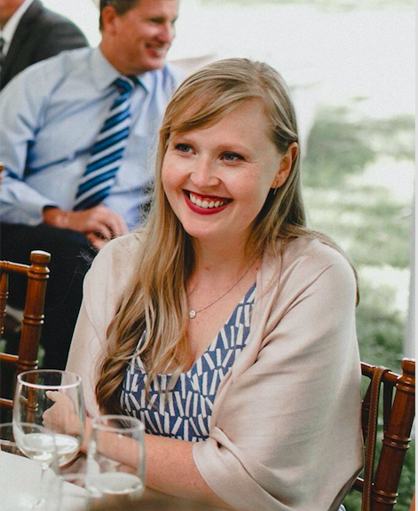 Colleen Cable sits at a table, smiling